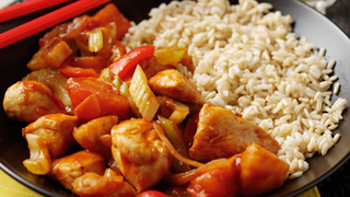 A roast chicken dinner, with potatoes, carrots, cabbage and gravy.